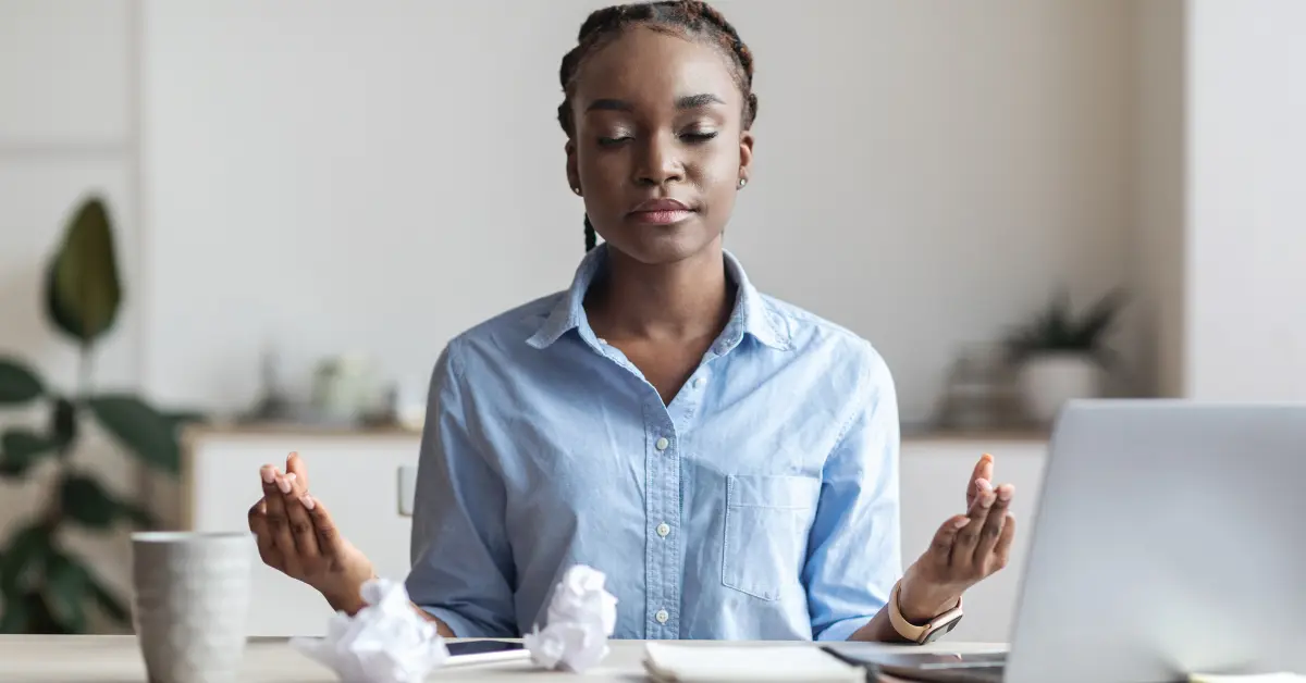 Woman practicing mindfulness at work for anxiety coping skills.